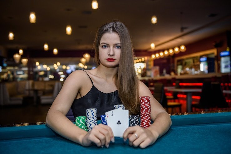 Blackjack dealer handling cards at live table